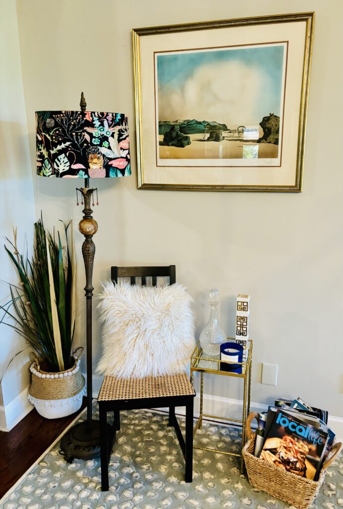 Pic of Black chair with rattan added styled with lamp and grasses